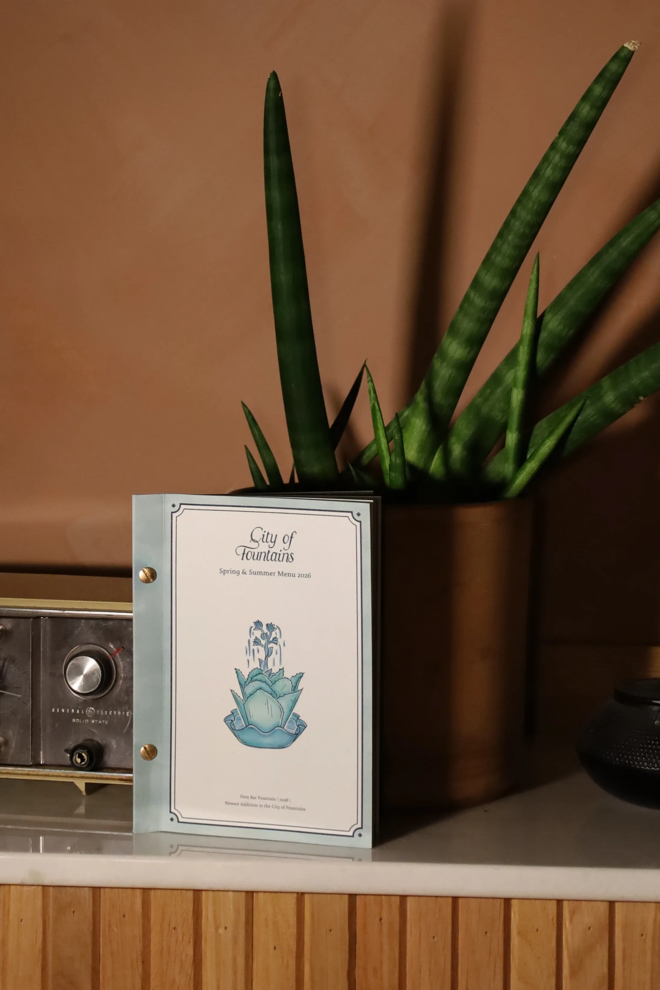 City of Fountains menu displayed on a bar counter at Fern Bar